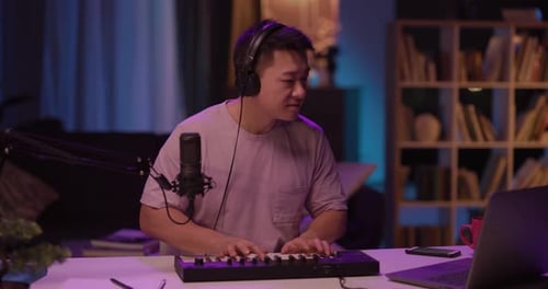 Man Composing Music at Home Studio at Night