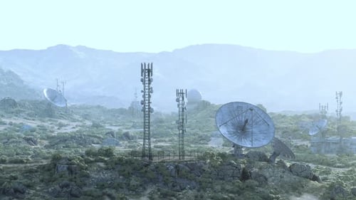 An Array of Surveillance Antennas in a Grassy Field at an Observatory