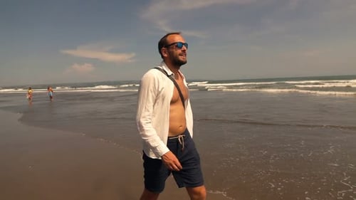Happy Young Man Walking on Beach During Sunny Day Super