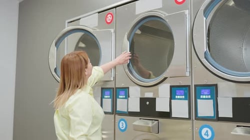Woman Cleaning Inside of Commercial Laundry Machine