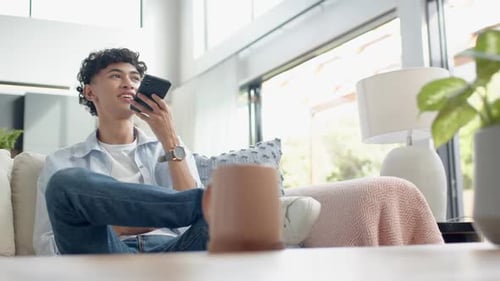 Young Adult Talking on Cell Phone on Sofa