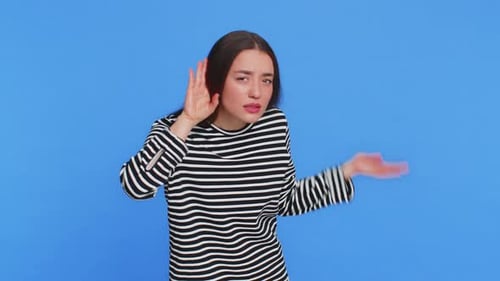 Caucasian Woman Trying Hear you Looking Confused and Frowning Keeping Arm Near Ear for Louder Voice
