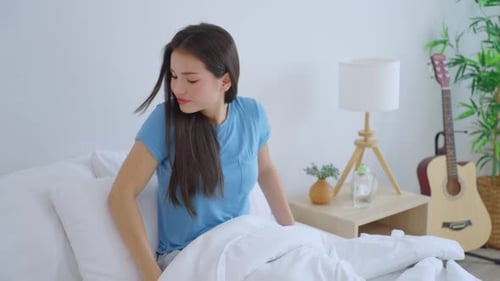 Woman Wakes Up and Yawns in Bed