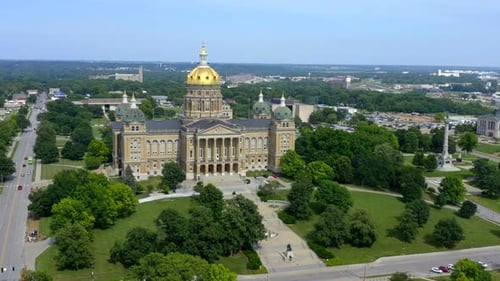 Des moines Iowa state capitol building aerial flyby on a sunny midwestern day