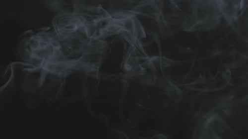 Wispy Smoke Drifting on Black Background