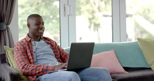 Young Adult Working on Laptop at Home