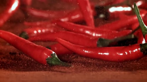 Red Chili Pepper in Flight with Ground Pepper Filmed on a Highspeed Camera at 1000 Fps