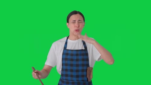 Indian housewife tasting spicy food Green screen