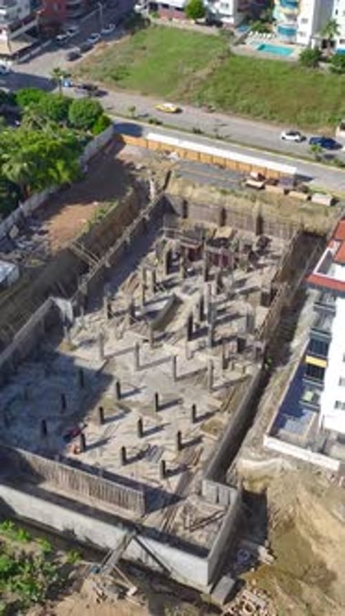 Vertical Video Workers Stay Busy Building Walls on a Construction Site Advancing the Structure with