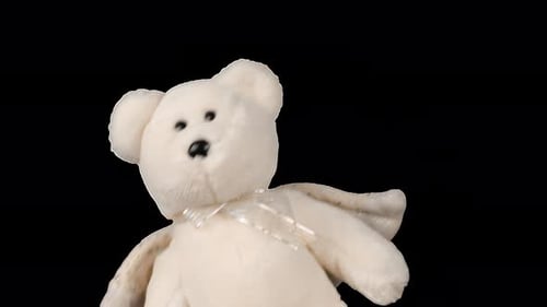 Stuffed and fluffy teddy bear toys with angel wings playing and dancing. Alpha channel included.
