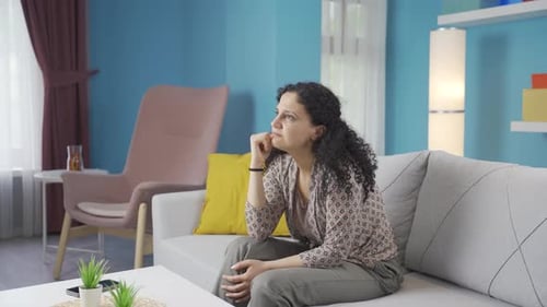 Woman Sitting on Sofa, Thinking Intensely