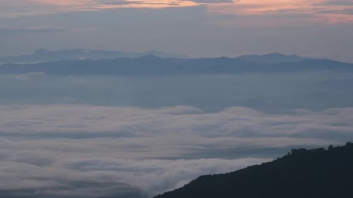 Aerial view of sea of fog on tropical mountains in the early morning.