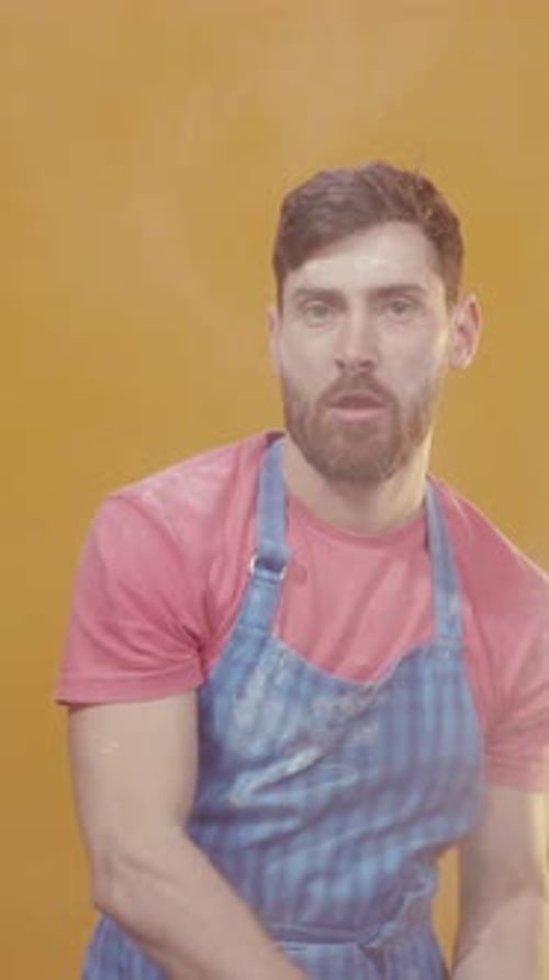 Silly Man Flipping Frying Pan on Orange Background