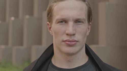 Portrait of Caucasian Guy Wearing Black Hood Outdoors