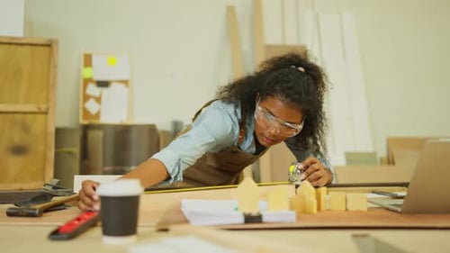 Professional carpenter or woodworker or charpenter woman use measuring tape to measure the lenght