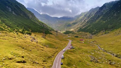 A highway built between the power line and river in the mountains.