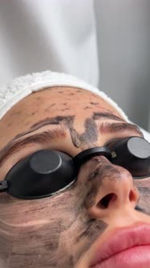 Woman Receives Facial Mask at Medical Clinic