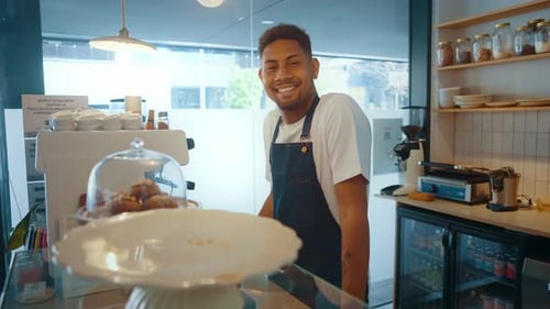 Cinematic image of waiters employees working in a nordic styled cafe.