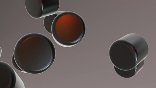 Cilindros voladores negros brillantes sobre fondo brillante