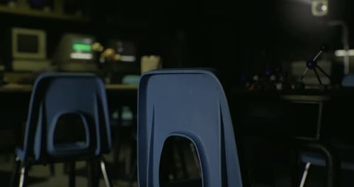 Empty Classroom with Blue Chairs and Dim Lighting in a Learning Space
