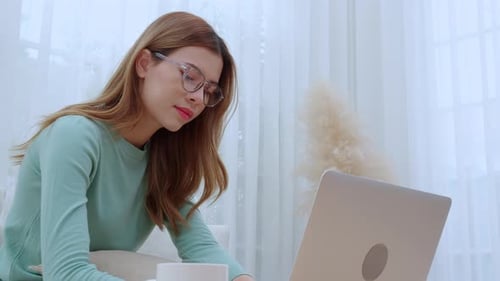 Woman with Laptop Working from Home