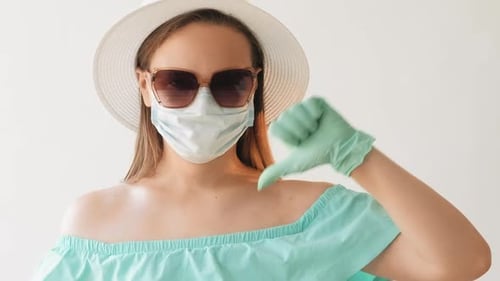 Woman Wearing PPE Gives Thumbs Down