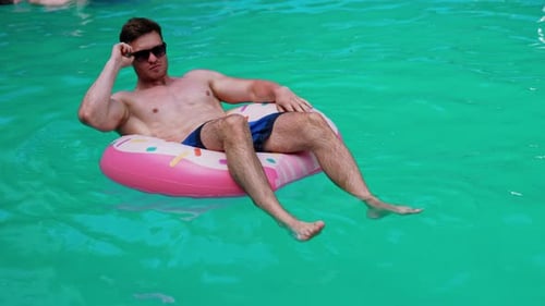 Water fun in sunny summer day. Summertime vaction man in pool having fun.