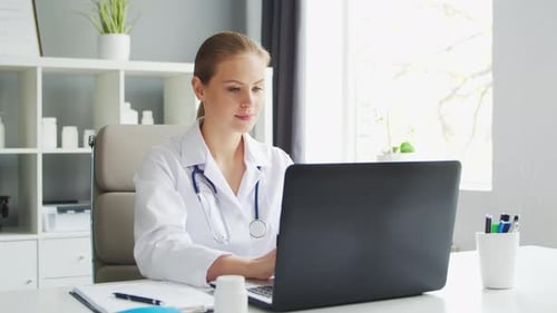 Doctor Works in the Medical Office Woman in White Coat Workplace of a Professional Female Therapist