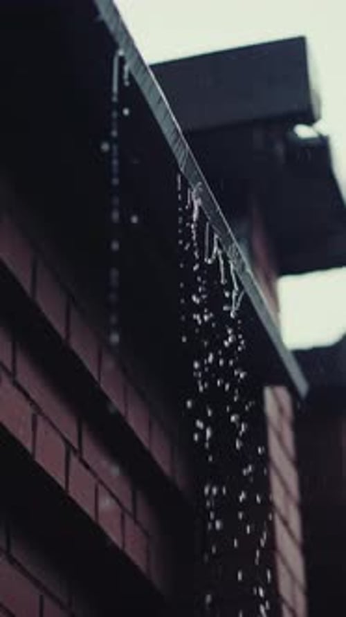 Rainwater Streaming Down Brick Gutter Gliding Smoothly in Slow Motion Depicting Serene Rainfall