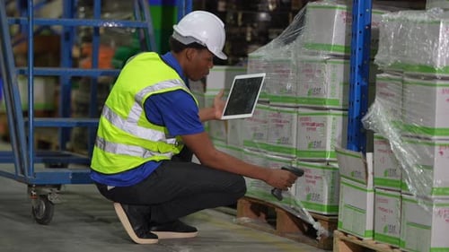 Worker Doing Inventory in Warehouse. Dispatcher in uniform making inventory in storehouse. supply ch