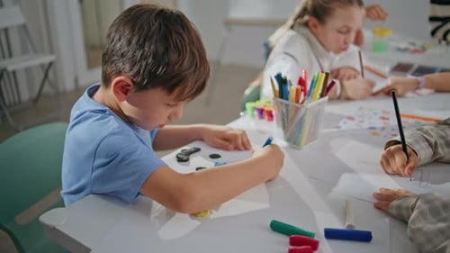 Little Boy Sculpting Plasticine at School Desk Closeup Pupil Creating Picture