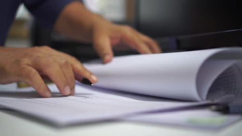 Hands Writing on Documents at Office Workplace Desk
