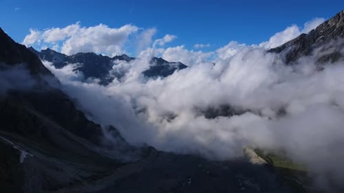 Clouds in Blue Sky Above Mountain Range in Natural Landscape