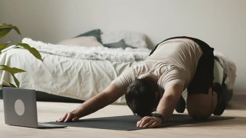 Man Doing Yoga Exercise at Home