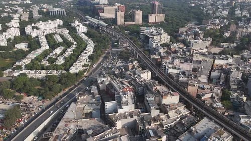Smooth drone shot capturing Gurugram’s illuminated skyline and busy highways, representing India’s