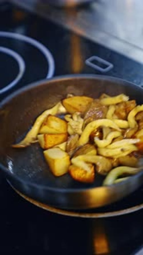 Potatoes and Onions Sizzle in a Hot Pan
