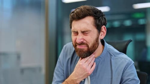 Bearded Man at Office Suffering From Sore Throat Tonsillitis or Other Sickness