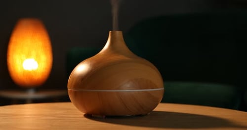 Essential Oil Diffuser Vaporizing on Table at Night