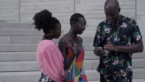 Stylish young friends enjoying social media in the city of New York