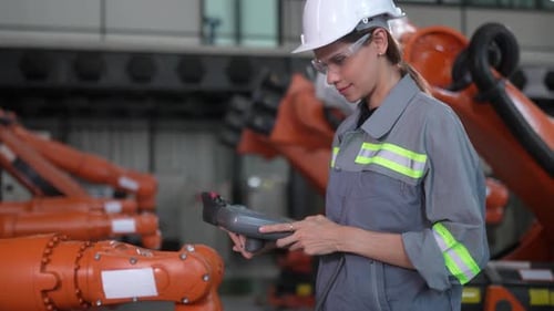Engineer woman working inside robotic factory - Tech industry concept