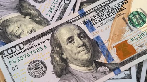 One hundred dollar banknote rotating on money background. Paper money, cash currency.