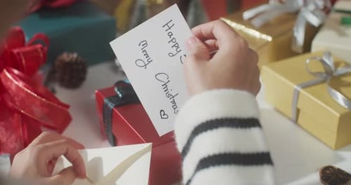 Close up of girl hands unpacking present gift box winter christmas decorations.