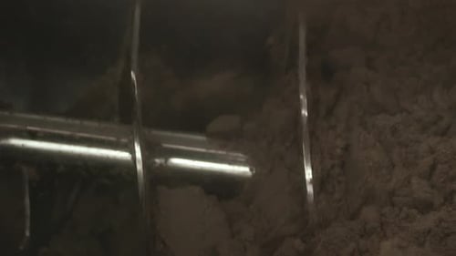 Industrial auger conveying malt in brewery