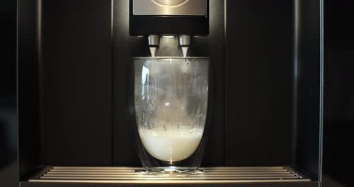 Milk Being Dispensed into a Glass from Machine