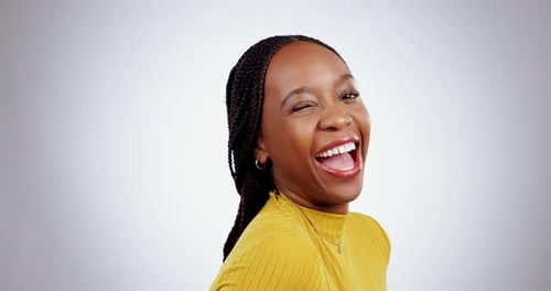 Face, woman and wink in studio with smile for confidence, expression and laughing on white