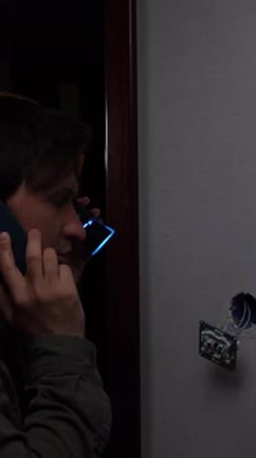 Young Adult with Phone and Electrical Components