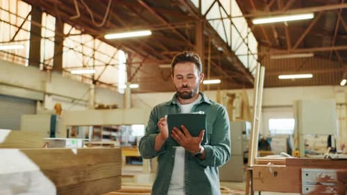 Carpentry, tablet and man in woodwork warehouse for furniture production