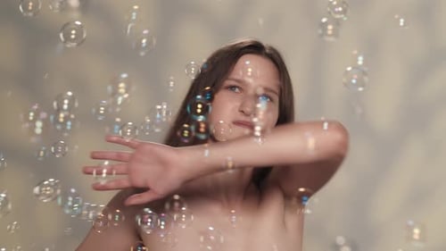 Appealing Caucasian Girl Distracted and Annoyed By Soap Bubbles Slow Motion