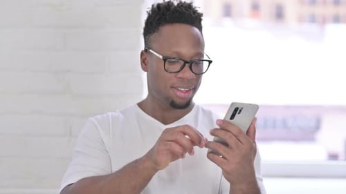 Young Adult Using Smartphone Indoors