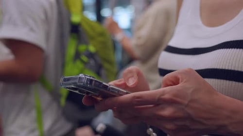 Close up of woman traveler using mobile phone while riding on the train.